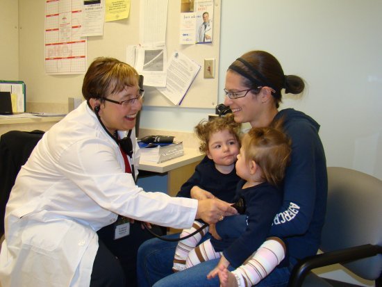 Mother with two young children at the doctor's office