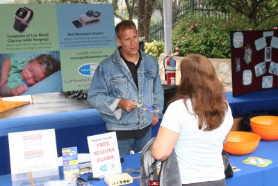 Man speaking to a woman at a informational stall